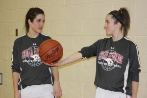 SISTERLY LOVE: Sisters Sayge Wight ’14 and Hannah Wight ’13 debate on a picture pose. The Wight’s compete side by side on the varsity basketball team. Basketball is just one of the many things they share in each other’s lives. Photo by Sirena Johnson ‘13